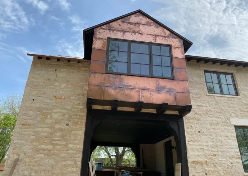 Copper metal panel facade on a stone building for Skylight Installation in Boise City