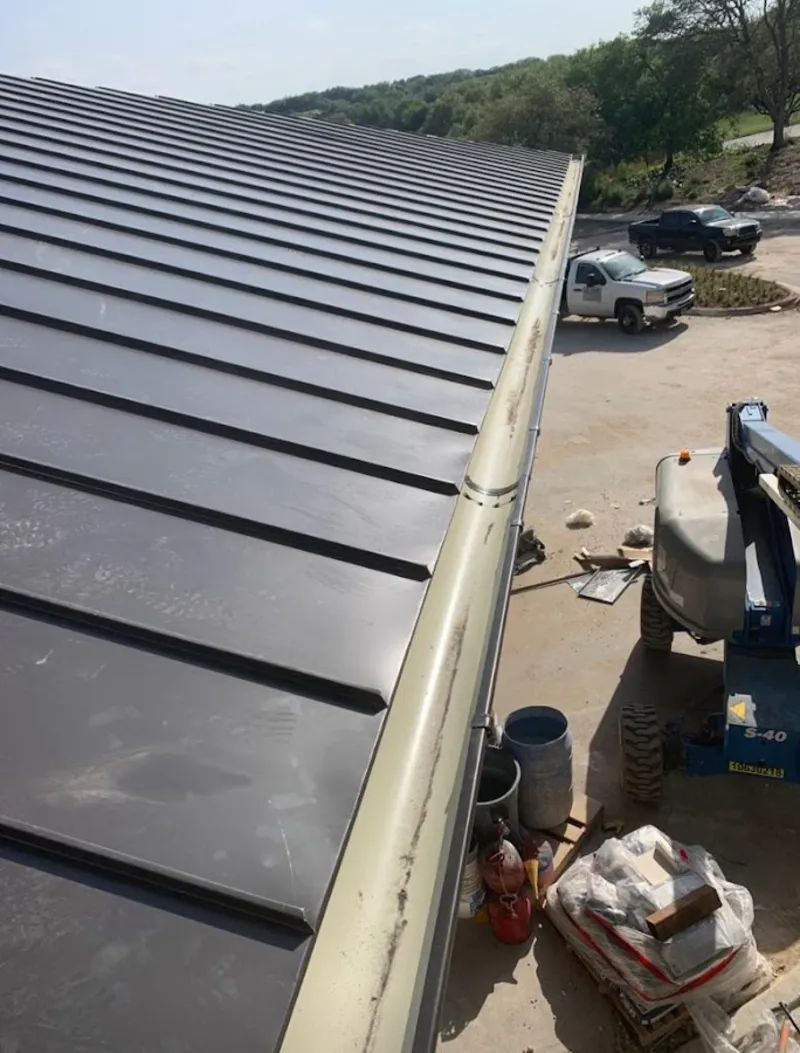 Standing seam panel and gutter detail on a metal roofing jobsite in Boise City